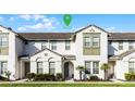 Charming townhome featuring neutral colors, well-maintained landscaping, and inviting front entrance at 434 Captiva Dr, Davenport, FL 33896