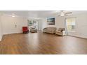 Bright living room with wood floors, comfortable seating, and natural light at 4758 Wyresdale St, Orlando, FL 32808