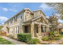 Charming two-story townhome featuring a covered front porch and beautifully landscaped front yard at 7127 Harmony Square S Dr # 7127, Harmony, FL 34773