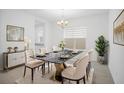 Elegant dining room featuring a marble table, plush chairs, and stylish decor at 13193 Tollcross Way, Winter Garden, FL 34787