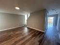 Spacious living room with wood-look flooring and access to other rooms at 523 Royal Ridge Dr, Davenport, FL 33837