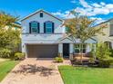 Inviting two-story home featuring a manicured lawn and a brick-paved driveway leading to a two-car garage at 5249 Villa Rosa Ave, St Cloud, FL 34771