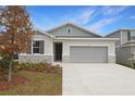 Charming home featuring stone accents, manicured landscaping, and a two-car garage at 1753 Carnelian St, Deland, FL 32720