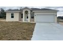 Newly built single story house featuring a two car garage and neutral color scheme at 1415 Orlando Way, Kissimmee, FL 34759