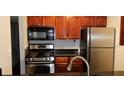 Modern kitchen with stainless steel appliances and wood cabinets at 2041 Dixie Belle Dr # 2041P, Orlando, FL 32812
