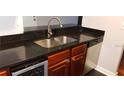 Kitchen features dark countertops, stainless steel sink and dishwasher at 2041 Dixie Belle Dr # 2041P, Orlando, FL 32812