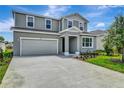 Charming two story home with a two-car garage and well-manicured lawn on a sunny day at 1769 Carnelian St, Deland, FL 32720