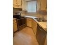 Kitchen featuring an oven, sink and wood cabinets at 1940 Lake Atriums Cir # 93, Orlando, FL 32839