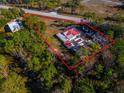 Aerial view showing house, lot, and surrounding trees at 1808 S Tanner Rd, Orlando, FL 32820