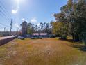 House with red roof, large lot, and road view at 1808 S Tanner Rd, Orlando, FL 32820
