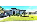 Charming single-story home boasts a well-manicured lawn, stone flower beds, two-car garage, and a tidy driveway at 3907 Golden Knot Dr, Kissimmee, FL 34746
