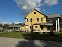 Charming yellow house with a large covered porch and a metal roof at 701 1St Ne St, Fort Meade, FL 33841