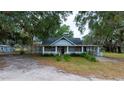 Rustic cottage exterior surrounded by oak trees at 8836 Sr 471 Hwy, Webster, FL 33597