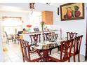 Features a glass dining table with ornate chairs adjacent to the kitchen, perfect for Gathering gatherings at 1053 Hemingway Dr, Deltona, FL 32725