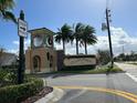 Community entrance sign for Champions Gate with decorative tower and well manicured greenery at 712 Whistling Straits Blvd, Davenport, FL 33896