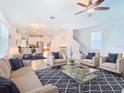 Spacious living area with modern furnishings and an open floor plan at 11720 Language Way, Orlando, FL 32832