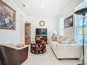 Bright living room showcasing a sofa, armchair, and decorative accents at 11720 Language Way, Orlando, FL 32832