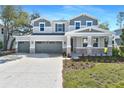 Charming two-story home boasts a three-car garage and inviting stone accents on a well-manicured front lawn at 3764 Deer Ridge Dr, Mount Dora, FL 32757