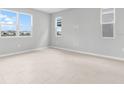 Bright bedroom with large windows and neutral-colored flooring at 1455 August Gray Dr, Kissimmee, FL 34744
