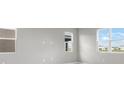 Bright and airy living space showcasing multiple windows and neutral walls at 1479 August Gray Dr, Kissimmee, FL 34744