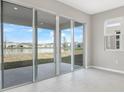Bright living space featuring a large sliding glass door with a beautiful water view at 1479 August Gray Dr, Kissimmee, FL 34744