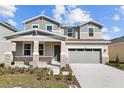 Charming two-story home featuring stone accents, a covered porch, and a well-maintained lawn at 1485 August Gray Dr, Kissimmee, FL 34744