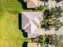 Aerial view of a well-maintained home featuring lush green lawn and a well-manicured landscape at 3643 Weatherfield Dr, Kissimmee, FL 34746