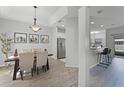 Bright, modern dining area with stylish light fixture, stainless appliances, and breakfast bar at 3643 Weatherfield Dr, Kissimmee, FL 34746