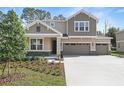 Charming two-story home with a two-car garage, landscaped yard, and manicured lawn at 3732 Deer Ridge Dr, Mount Dora, FL 32757