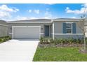 Inviting one-story home featuring a well-manicured lawn and a pristine, two-car garage at 652 Hennepin Loop, Lake Wales, FL 33898