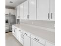 Bright kitchen featuring white cabinets, stainless steel appliances, and elegant quartz countertops at 3824 Deer Ridge Dr, Mount Dora, FL 32757