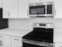 Stainless steel appliances and white countertops in kitchen at 520 Summit River Dr, Apopka, FL 32712