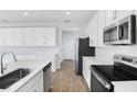 Modern kitchen with white cabinets and stainless steel appliances at 520 Summit River Dr, Apopka, FL 32712