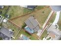 Expansive aerial view showcasing the house on a corner lot, mature trees, lawn, and a screened-in pool at 1855 Cavalier Ct, Kissimmee, FL 34744