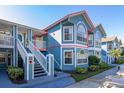 Charming two-story condo with blue siding, white trim, and well-maintained landscaping at 8716 Rain Forest Pl # D, Kissimmee, FL 34747