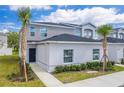 Townhome features gray exterior, landscaping, and walkway at 2023 Claudia Ln, Kissimmee, FL 34741
