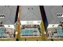 Aerial view of the home's back yard with in-ground pool enclosed by white screen, bordered by green grass at 8932 Cabot Cliffs Dr, Davenport, FL 33896