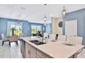 Modern kitchen with island and stainless steel appliances at 8932 Cabot Cliffs Dr, Davenport, FL 33896