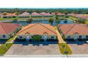 Aerial view of residences with tile roofs, manicured landscaping, and a beautiful lake at 1819 Coriander Dr # 1819, Kissimmee, FL 34759