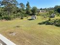 Expansive backyard with mature trees, shed, and sunny lawn at 20526 Quinella St, Orlando, FL 32833