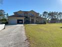 Spacious home with two-car garage, driveway, and expansive lawn at 20526 Quinella St, Orlando, FL 32833