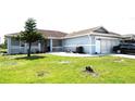 Single-story house featuring well-maintained lawn, covered porch, and attached garage at 101 Whitehall Way, Kissimmee, FL 34758