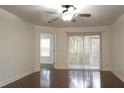 Spacious bedroom with hardwood floors and access to a balcony at 8846 Coral Palms Ct # A, Kissimmee, FL 34747