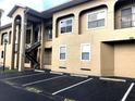 Condo building exterior with visitor parking, multiple units, and convenient outdoor staircases for upper-level access at 8846 Coral Palms Ct # A, Kissimmee, FL 34747