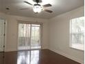 Bright living room featuring hardwood floors and sliding glass doors at 8846 Coral Palms Ct # A, Kissimmee, FL 34747