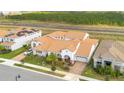 Aerial view of home showcasing a red-tiled roof, lush landscaping, and a convenient two-car garage at 13809 Abberwick Dr, Orlando, FL 32832