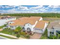 Stunning home showcasing a red-tiled roof, lush landscaping, stone accents, and a convenient two-car garage at 13809 Abberwick Dr, Orlando, FL 32832