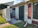 Home exterior showing front door, entryway, and partial siding at 98 Pine Island Cir, Kissimmee, FL 34743