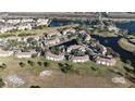 Aerial view of a community with buildings, landscaping, and lakes at 13838 Fairway Island Dr # 1432, Orlando, FL 32837