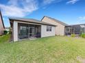 Spacious backyard with grassy area and screened porch at 516 Pamplona Pl, Davenport, FL 33837